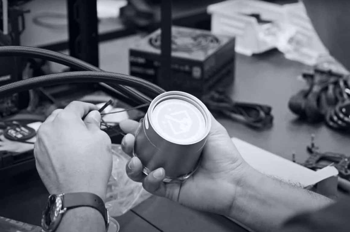 A close up shot of an individual's hands working with PC wiring and parts.